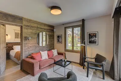 a living room with a couch and a bed at White Pearl A05 Modern apartment Chamonix Alpes Travel Sleeps 4 to 6 in Chamonix-Mont-Blanc