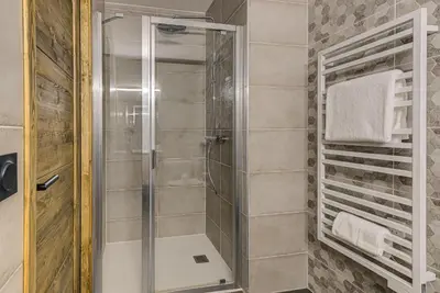 a shower with a glass door in a bathroom at White Pearl A05 Modern apartment Chamonix Alpes Travel Sleeps 4 to 6 in Chamonix-Mont-Blanc