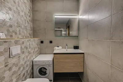 a bathroom with a washing machine and a sink at White Pearl A05 Modern apartment Chamonix Alpes Travel Sleeps 4 to 6 in Chamonix-Mont-Blanc