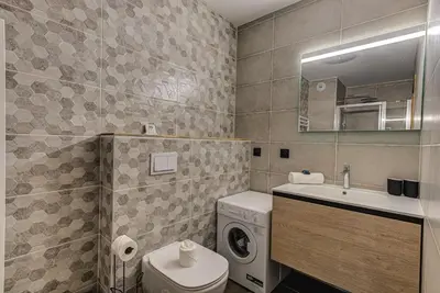 a bathroom with a washing machine and a washer at White Pearl A05 Modern apartment Chamonix Alpes Travel Sleeps 4 to 6 in Chamonix-Mont-Blanc