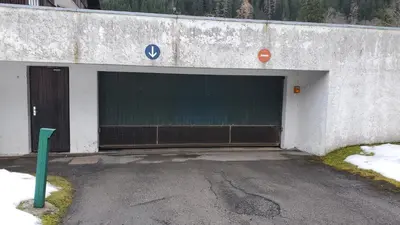 a garage with a large door in the side of a building at SKI AUX PIEDS et PIEDS DANS L'EAU in Les Contamines-Montjoie