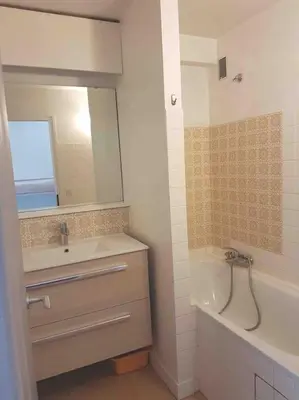 a bathroom with a sink and a tub and a mirror at SKI AUX PIEDS et PIEDS DANS L'EAU in Les Contamines-Montjoie