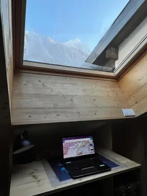 a laptop sitting on a shelf next to a window at Le Petit Cham in Chamonix-Mont-Blanc