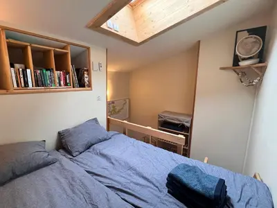 a bedroom with a bed and a mirror at Le Petit Cham in Chamonix-Mont-Blanc