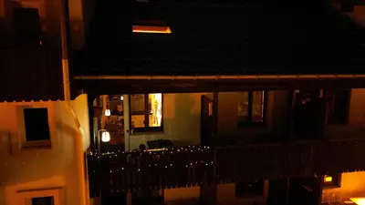 a view of a balcony of a building at night at Le Petit Cham in Chamonix-Mont-Blanc