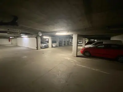 a parking garage with two cars parked in it at Le Petit Cham in Chamonix-Mont-Blanc