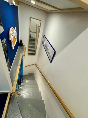 a staircase in a house with a blue and white wall at Le Petit Cham in Chamonix-Mont-Blanc