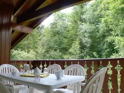 a white table and chairs on a deck with trees at Appartement T4 pour 8 pers, animaux admis, parking - FR-1-629-131 in Samoëns