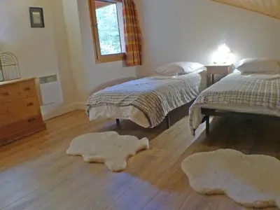 a bedroom with two beds and two rugs on the floor at Appartement T4 pour 8 pers, animaux admis, parking - FR-1-629-131 in Samoëns