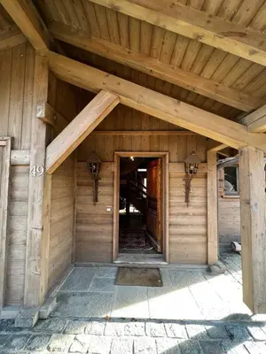 a kitchen with a wooden table and a large window at Chalet Canopée in Demi-Quartier