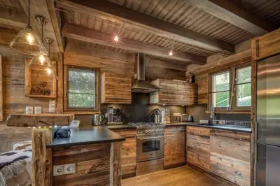 a living room with a couch and a table at Chalet Canopée in Demi-Quartier