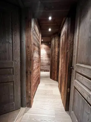 a wooden bathroom with a toilet and a sink at Chalet Canopée in Demi-Quartier