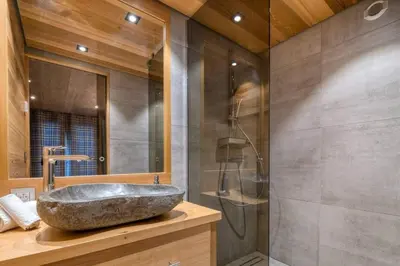 a bathroom with a sink and a glass shower at Chalet Canopée in Demi-Quartier