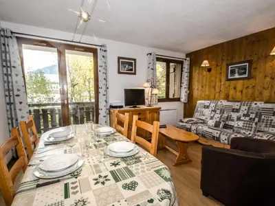 a dining room and living room with a table and chairs at Appartement avec balcon, parking et animaux acceptés à Chamonix - FR-1-343-245 in Chamonix-Mont-Blanc