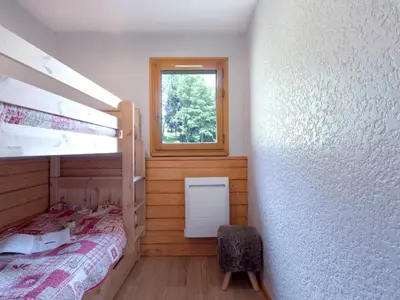 a bedroom with two bunk beds and a window at Studio Les Tétras by Interhome in Saint-Gervais-les-Bains