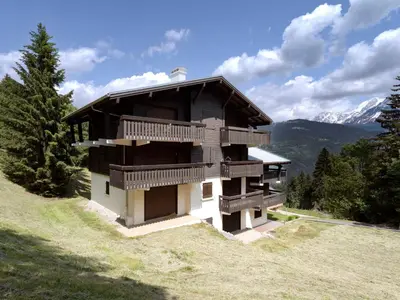 a building on the side of a hill with trees at Studio Les Tétras by Interhome in Saint-Gervais-les-Bains