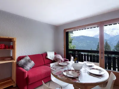a dining room with a table and chairs and a television at Studio Les Tétras by Interhome in Saint-Gervais-les-Bains