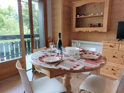 a living room with a red couch and a table at Studio Les Tétras by Interhome in Saint-Gervais-les-Bains