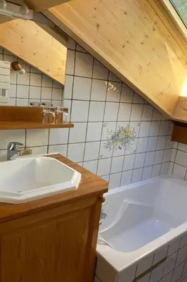 a bathroom with a sink and a bath tub at Apartment Village des Oursons Chalet A4 by Interhome in Chamonix-Mont-Blanc