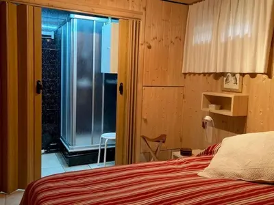 a bedroom with a bed and a sliding glass door at Apartment Village des Oursons Chalet A4 by Interhome in Chamonix-Mont-Blanc