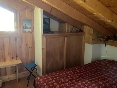 a bedroom with a bed and a window in a room at Apartment Village des Oursons Chalet A4 by Interhome in Chamonix-Mont-Blanc
