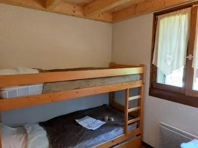 a bedroom with a bed in a wooden cabin at Studio La Jacquerie by Interhome in Demi-Quartier