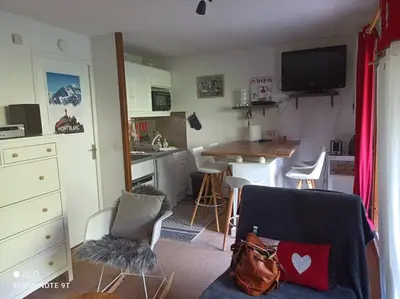 a small kitchen with a couch and a table in a room at Appartement en rez de jardin vue montagne in Les Contamines-Montjoie
