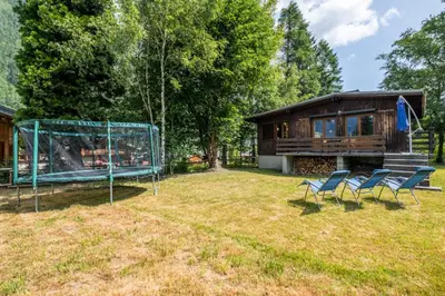 a group of chairs in a yard with a house at Rustic chalet with garden in Chamonix in Chamonix-Mont-Blanc