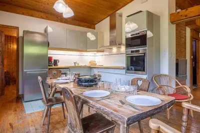 a kitchen with a wooden table and chairs at Rustic chalet with garden in Chamonix in Chamonix-Mont-Blanc