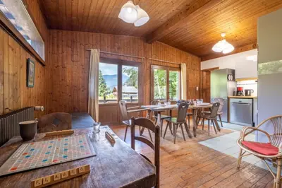 a dining room with wooden walls and tables and chairs at Rustic chalet with garden in Chamonix in Chamonix-Mont-Blanc