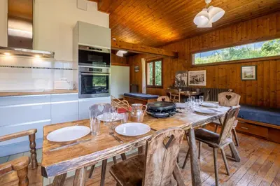 a kitchen and dining room with a wooden table and chairs at Rustic chalet with garden in Chamonix in Chamonix-Mont-Blanc