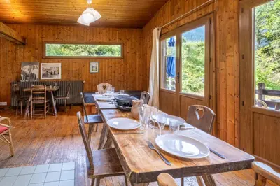 a wooden dining room with a long table and chairs at Rustic chalet with garden in Chamonix in Chamonix-Mont-Blanc