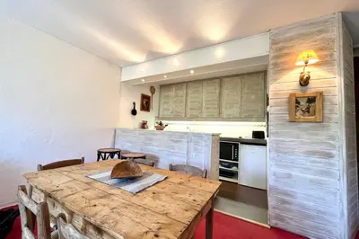 a kitchen with a wooden table in a room at Nid d'Arbois in Megève