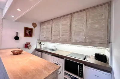 a kitchen with wooden cabinets and a counter top at Nid d'Arbois in Megève