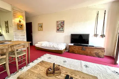 a living room with a flat screen tv and a couch at Nid d'Arbois in Megève