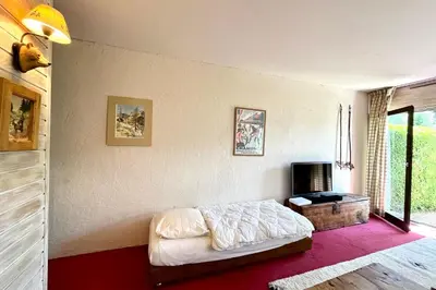 a bedroom with a bed and a tv in it at Nid d'Arbois in Megève