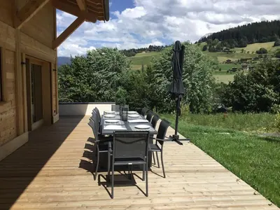 a living room with a couch and two tables at Chalet du Feug in Combloux