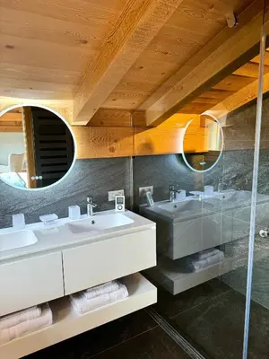a bathroom with two sinks and a mirror at Chalet du Feug in Combloux