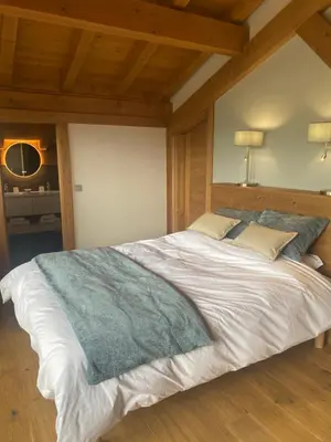 a bedroom with a bed and a tv on a table at Chalet du Feug in Combloux