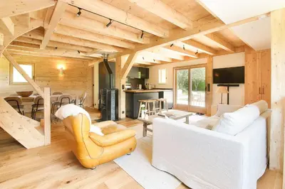 a living room with a white couch and a table at Chalet Béchar Le Magnifique- Garden - Sauna & Jacuzzi in Les Houches