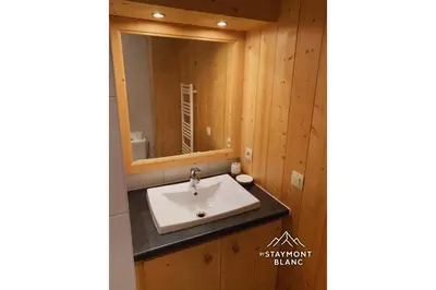 a bathroom with a sink and a mirror at Appartements 2 pièces vue Mont-Joly à 2 pas Tramway Mont-Blanc in Saint-Gervais-les-Bains