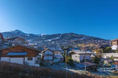 a view of a town with mountains in the background at Appartements 2 pièces vue Mont-Joly à 2 pas Tramway Mont-Blanc in Saint-Gervais-les-Bains