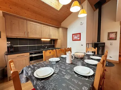 a kitchen with a table with plates on it at Spacieux duplex dans une résidence avec piscine - FR-1-624-137 in Samoëns