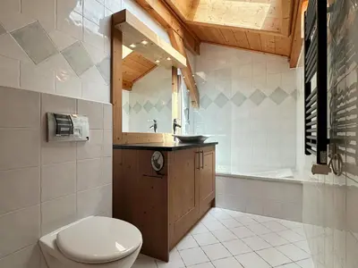 a bathroom with a toilet and a sink and a tub at Spacieux duplex dans une résidence avec piscine - FR-1-624-137 in Samoëns