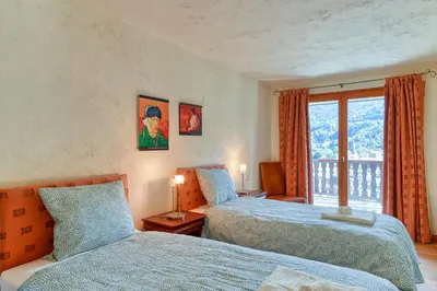 a bedroom with two beds and a window at Les Terrasses de Bel Alp in Saint-Gervais-les-Bains