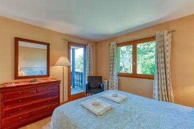 a bedroom with a bed and a dresser and a mirror at Les Terrasses de Bel Alp in Saint-Gervais-les-Bains
