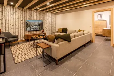 a living room with a couch and a table at Chalet Bonnabelle - Chamonix All Year in Chamonix-Mont-Blanc