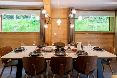a dining room with a table and chairs at Chalet Bonnabelle - Chamonix All Year in Chamonix-Mont-Blanc