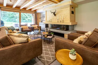 a living room with couches and a fireplace at Chalet Bonnabelle - Chamonix All Year in Chamonix-Mont-Blanc