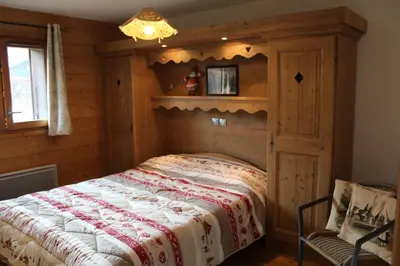 a bedroom with a bed in a log cabin at Chardons Argentés in Samoëns